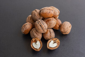 Nuts on dark table with walnut kernels colorful background.