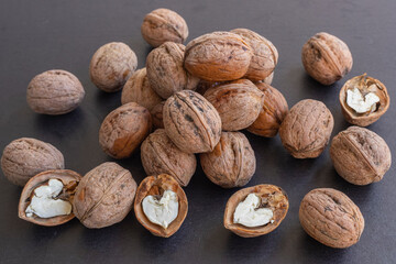 Nuts on dark table with walnut kernels colorful background.