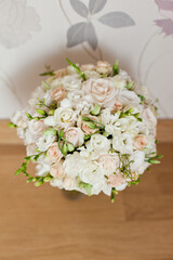 delicate wedding bouquet on background of room