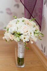 delicate wedding bouquet on background of room