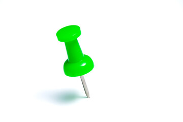 Green push pin or thumbtack isolated on a white background.