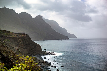 Black sand volcanic beach and view of Anaga mountains on northern coast Tenerife island, Spain