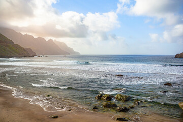 Black sand volcanic beach and view of Anaga mountains on northern coast Tenerife island, Spain