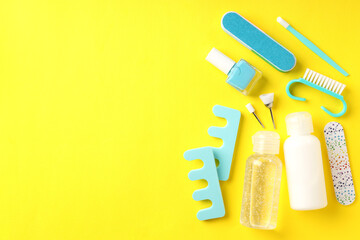 Concept of nail care with manicure accessories on yellow background