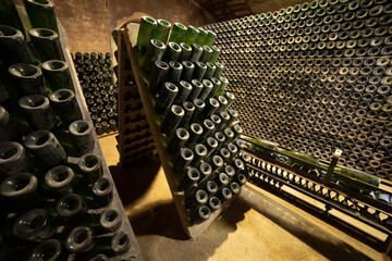 Vintage and dust champagne bottles in an old winery