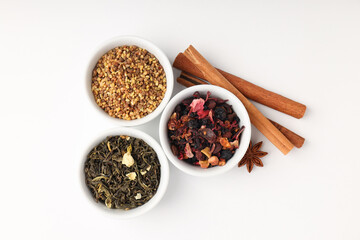 Concept of cooking tea with different types of tea on white background