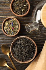 Concept of cooking tea with different types of tea on wooden background