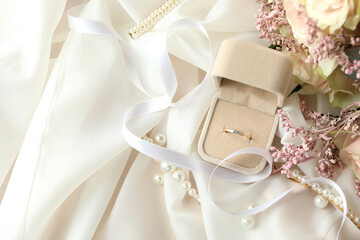 Concept of wedding accessories with wedding ring, close up