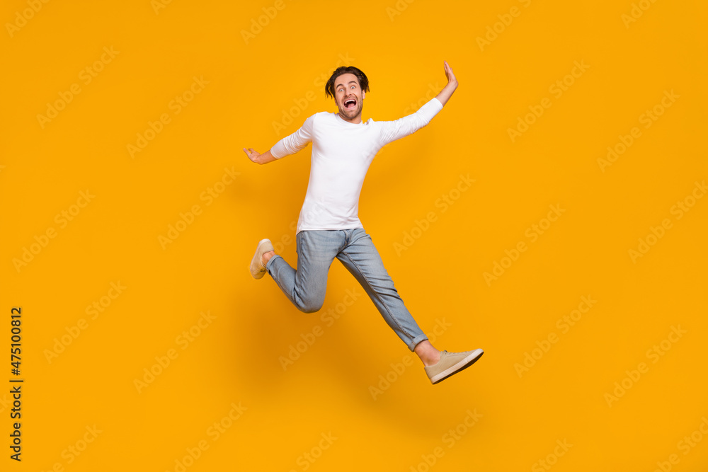 Sticker Full body photo of scared brunet young guy run wear shirt jeans sneakers isolated on yellow background