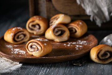 Fresh pastries with cinnamon on a rustic table