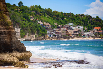 Beautiful sunny Dreamland beach with villas and beach houses along the coast, Bali, Indonesia