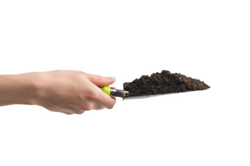 Little green shovel with soil in woman hand isolated.
