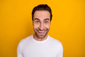 Deurstickers Photo of young cheerful guy have fun toothy smile wear casual clothes isolated over yellow color background © deagreez