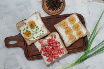 Bread has cream cheese and pomegranate boiled egg banana on white background.