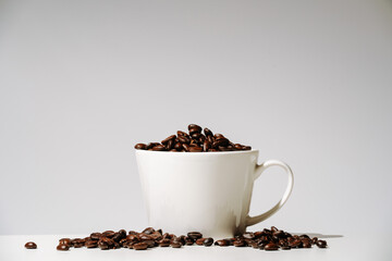 coffee beans in cup on white background