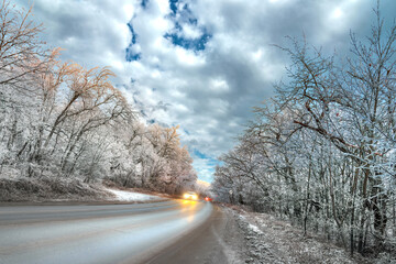 asphalt road winter panorama in countryside travel on cold snowy day. safety drive winter wet road...
