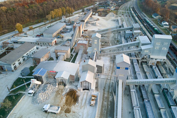 Aerial view of cargo train loaded with crushed stone materials at mining factory. Railway...
