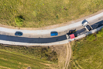 Aerial view of new road construction with asphalt laying machinery at work