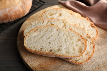 Slices of tasty wheat sodawater bread on wooden table