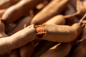 Tropical Sweet Ripe Tamarind Fruits. A top view selective focused shot of ripe tamarind for cooking as a ingredient. No shell tamarind thai food background concept.