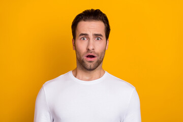 Photo of young man astonished frightened failure open mouth crazy isolated over yellow color background