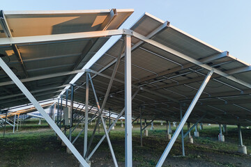 Ground based steel frame of large sustainable electrical power plant with rows of solar photovoltaic panels for producing clean ecological electric energy