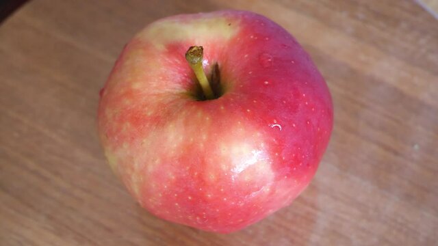 One pink apple of the ligol variety, video. Fruit close-up.
