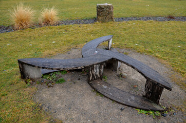 wooden bench in the park in winter. cubes and blocks also stone blocks of coarse limestone from the...