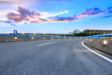 Empty asphalt road with modern skyline and buildings at the airport