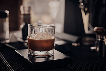 black drip coffee in glass cup.