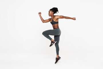 Fototapeta na wymiar Black young sportswoman doing exercise while working out