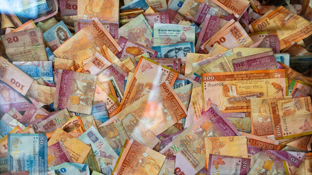 multiple Srilankan notes in a glass box