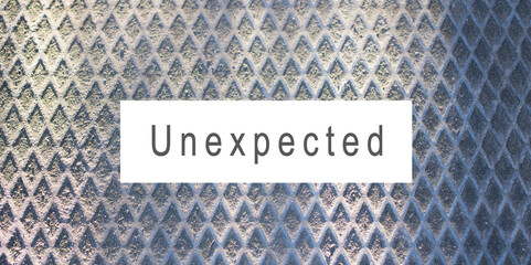 Metallic background with rhombuses and the text unexpected 