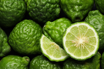 Whole and cut ripe bergamot fruits as background, top view