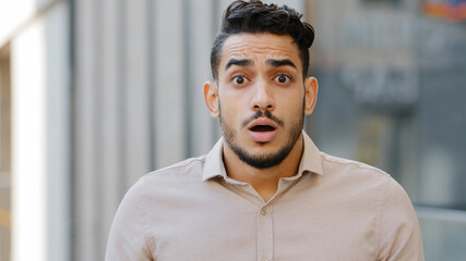 Portrait of young shocked surprised man close up scared frightened guy feeling shock surprise...