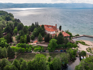 Obraz premium Drone shot of the monastery of St. Naum. An Orthodox monastery in North Macedonia drone view. Monastery of St. Naum on a hill near Lake Ohrid. Green hilly mountains in Macedonia.