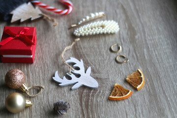 Wool stocking with small presents and Christmas decorations on wooden background. Selective focus.