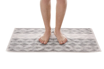 Man standing on stylish bath mat against white background, closeup