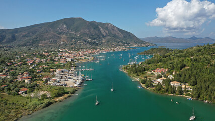 Fototapeta na wymiar Aerial drone photo of fjord shaped port of Nydri a calm sea safe anchorage for sail boats and yachts famous for trips to Meganisi, Skorpios and other Ionian islands, Lefkada island, Greece