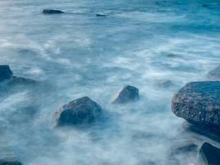 blurred water movement over rocks in the sea	
