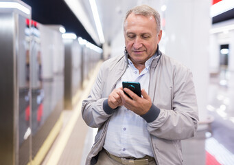 Middle aged man waiting for train in subway station