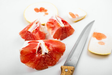 Piece of sweet red grapefruit, nice structure. On white.
