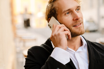 Blonde bristle man talking on mobile phone outdoors