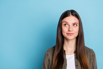 Fototapeta premium Photo of shiny charming young woman dressed khaki shirt smiling looking empty space isolated blue color background