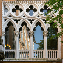 Marble window in Venetian gothic style with ogee arches and quatrefoils
