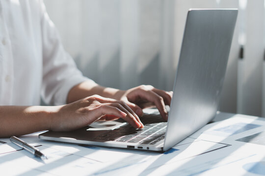 Close up of businessman or accountant working on laptop computer for calculate business data, accounting document and calculator at office, business concept