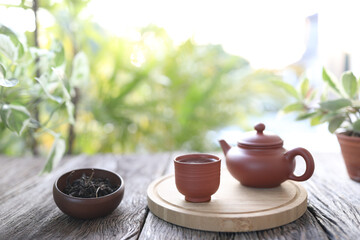 Tea cup and tea pot on wooden tray