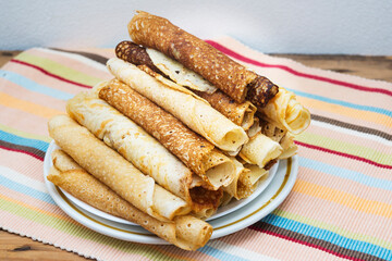 stack of rolled traditional Russian pancakes, blini, close up