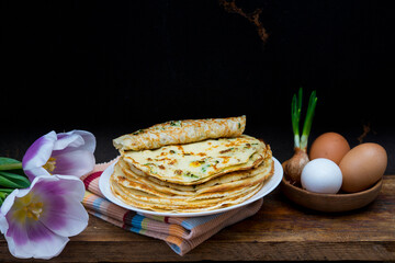 traditional Russian pancakes, blini, with green onion and egg for Maslenitsa celebration