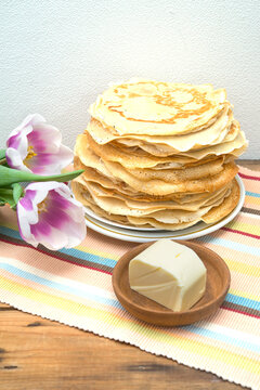 stack of traditional Russian pancakes, blini, and buter for Maslenitsa celebration on table